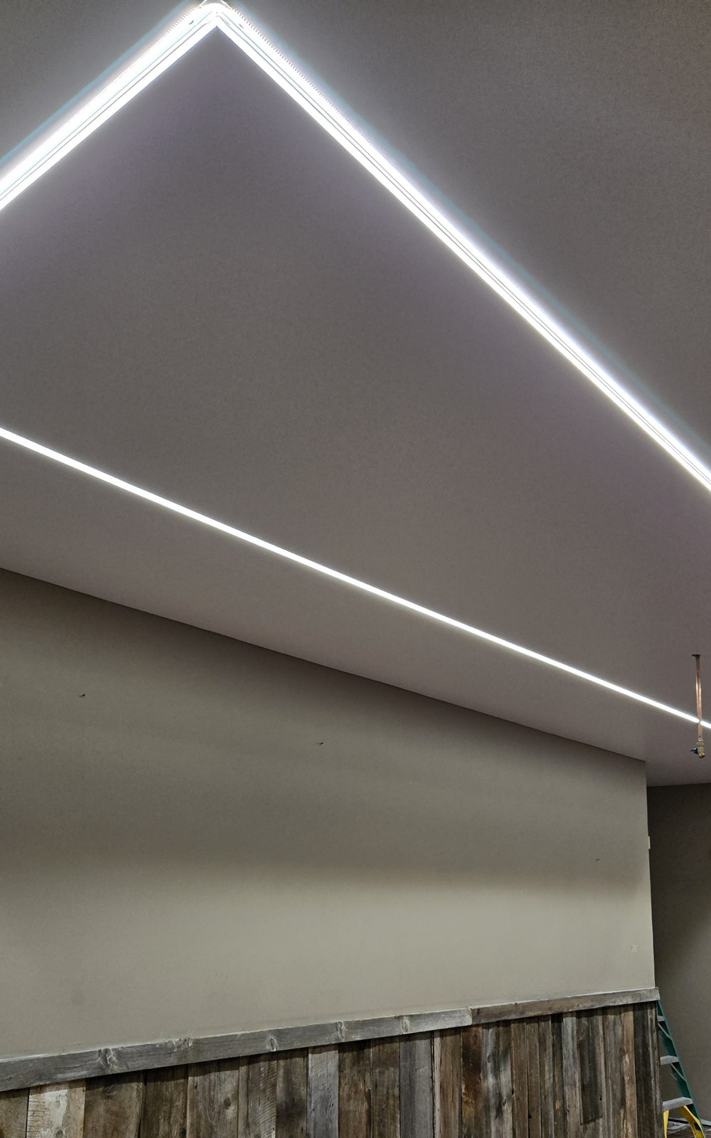 Smooth finished stretch ceiling with integrated linear lighting