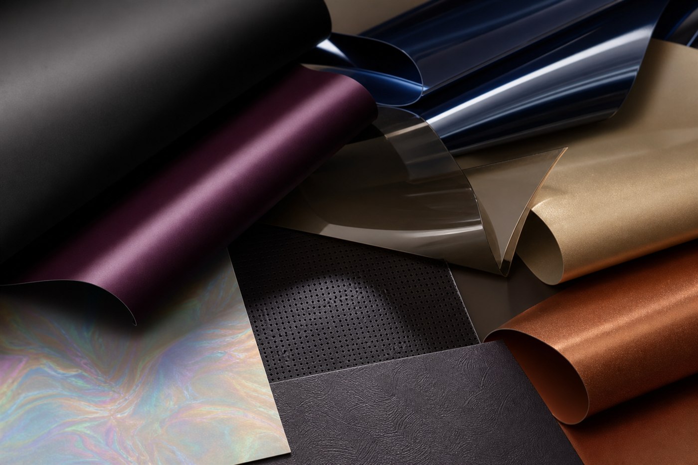 Concept samples showing matte black, aubergine satin, mirror gloss, smoked translucent, pearlescent, metallic, acoustic, and textured finishes
